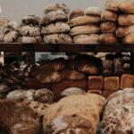 variety of artisan loaves and a wooden shelf