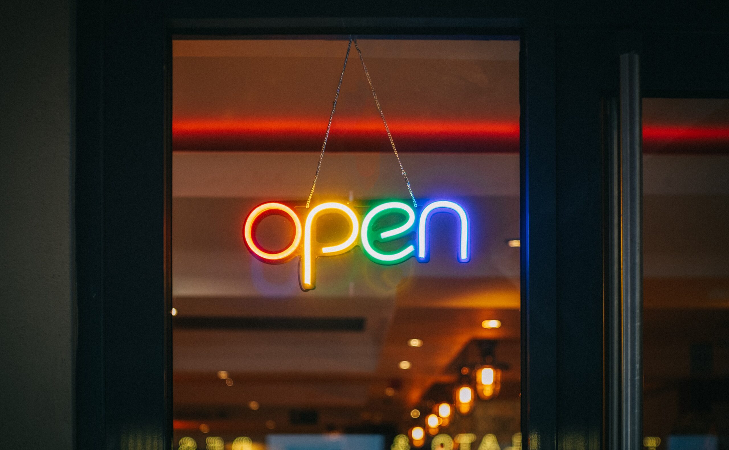 colourful illuminated sign that say 'opne'