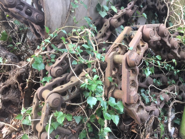 machinery chain entangled in hedgerow