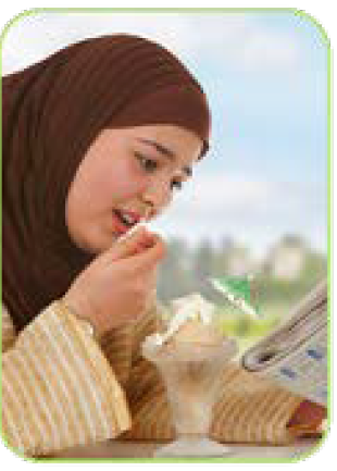 woman in hijab reading newspaper eating sundae