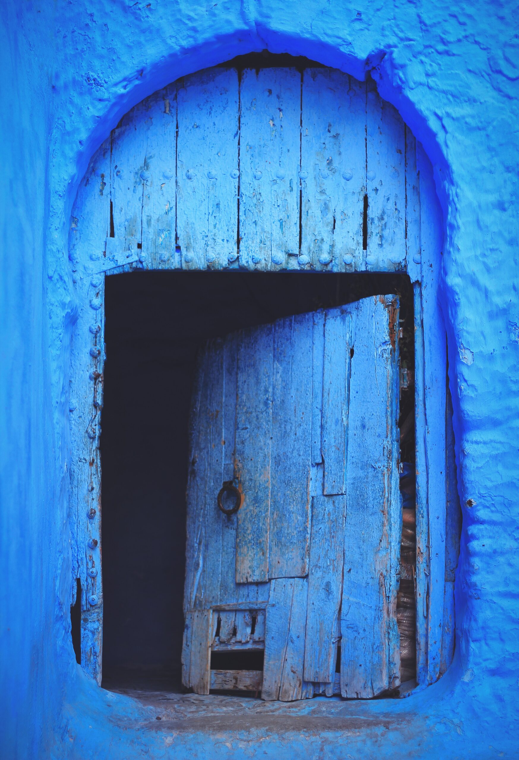 blue wooden door in wall opening inwards