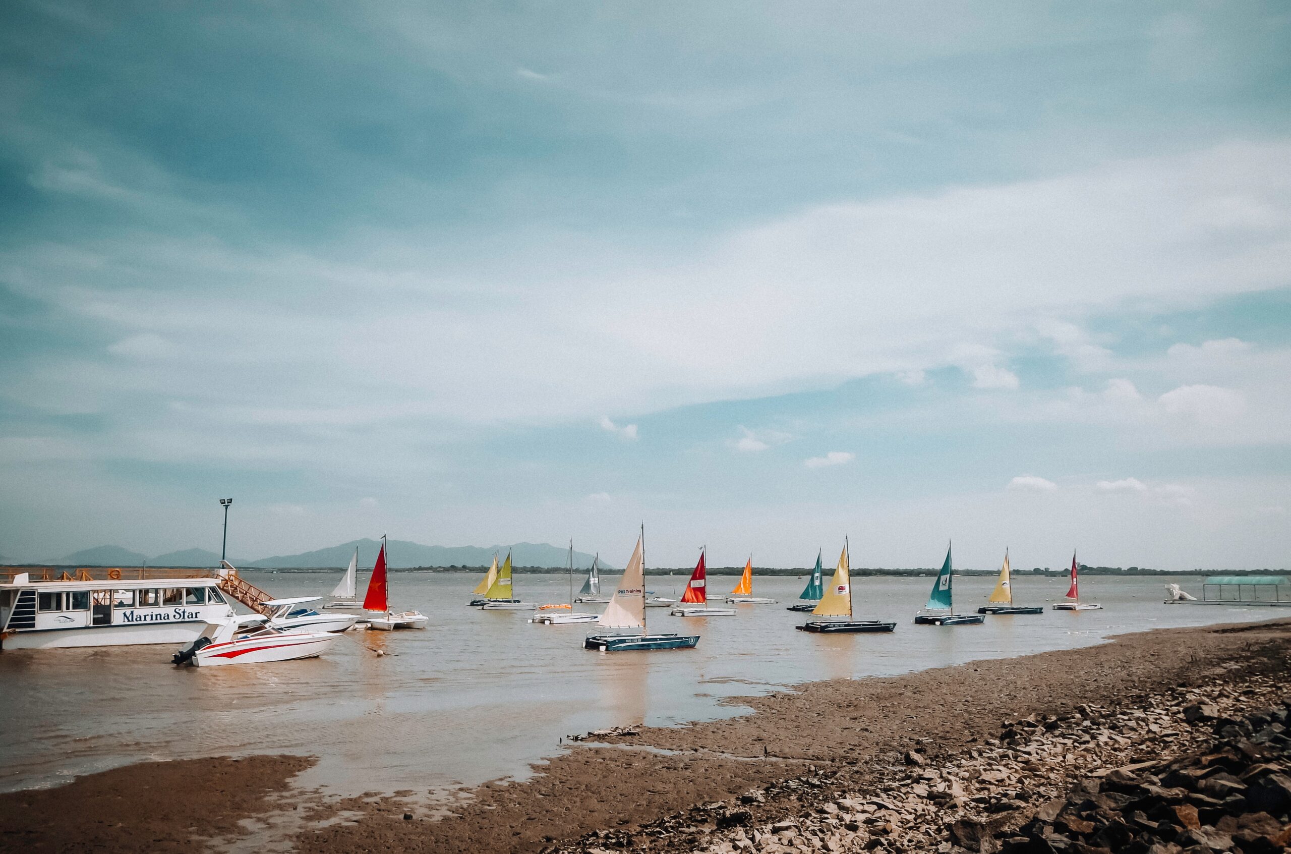 sailing boats by sea shore