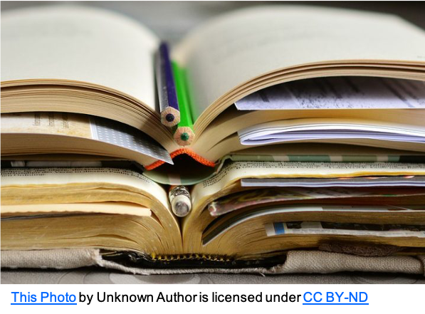 open books piled up with paper and pencils marking pages 