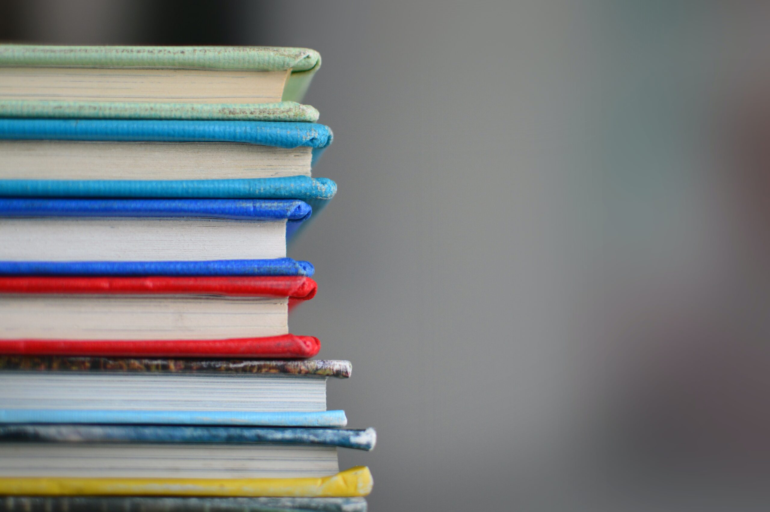 stack of colourful hardback books half in frame 